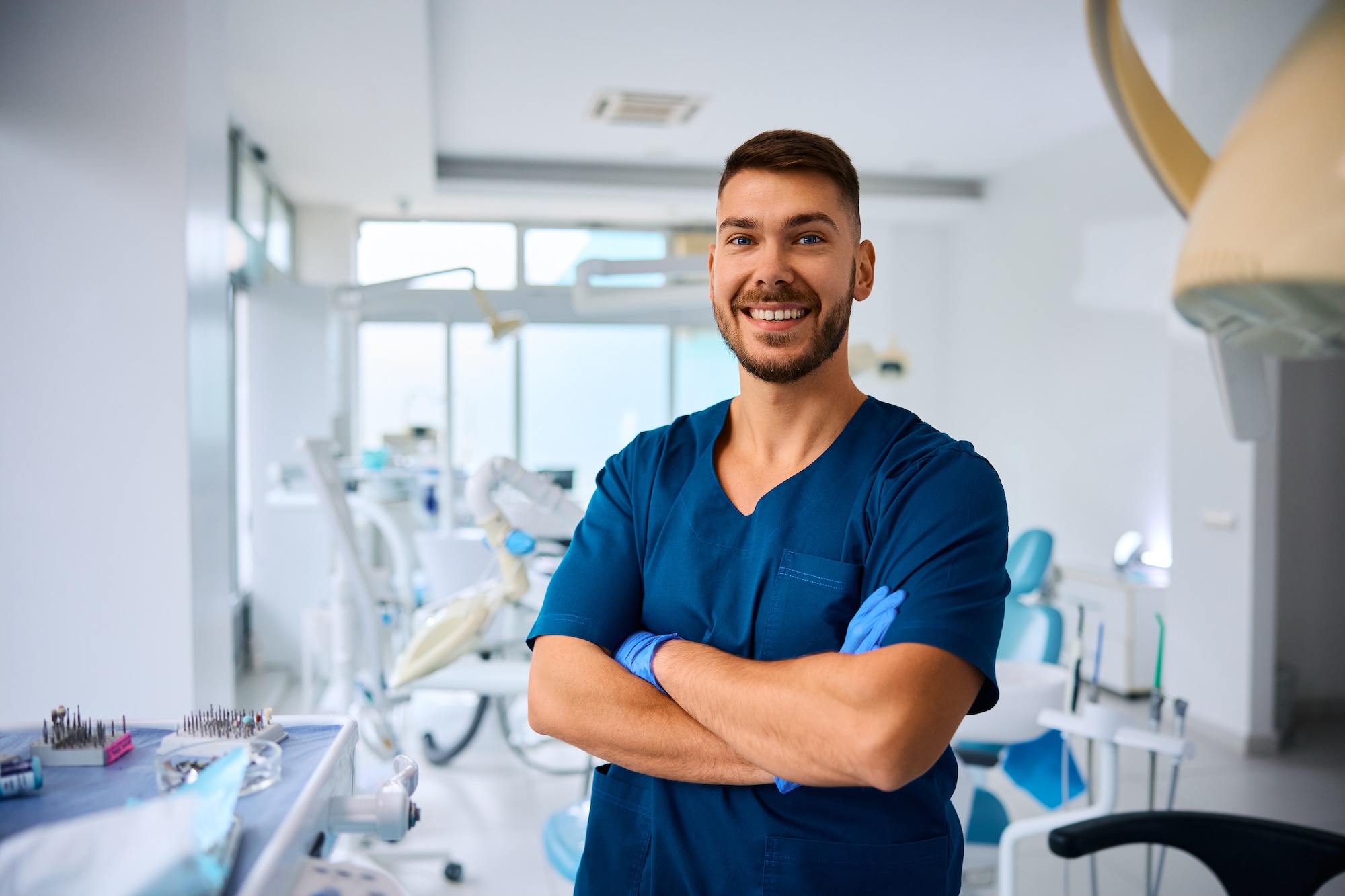 A dentist male arms crossed operatory