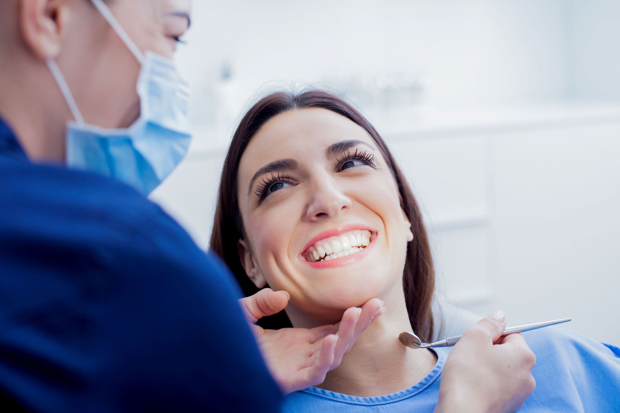 A woman chair smiling with dentist