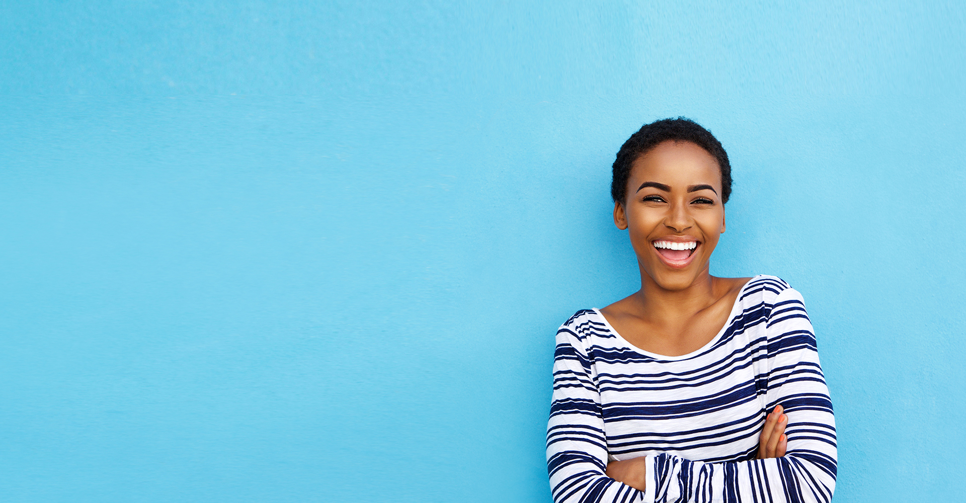 A woman striped shirt, against a blue background