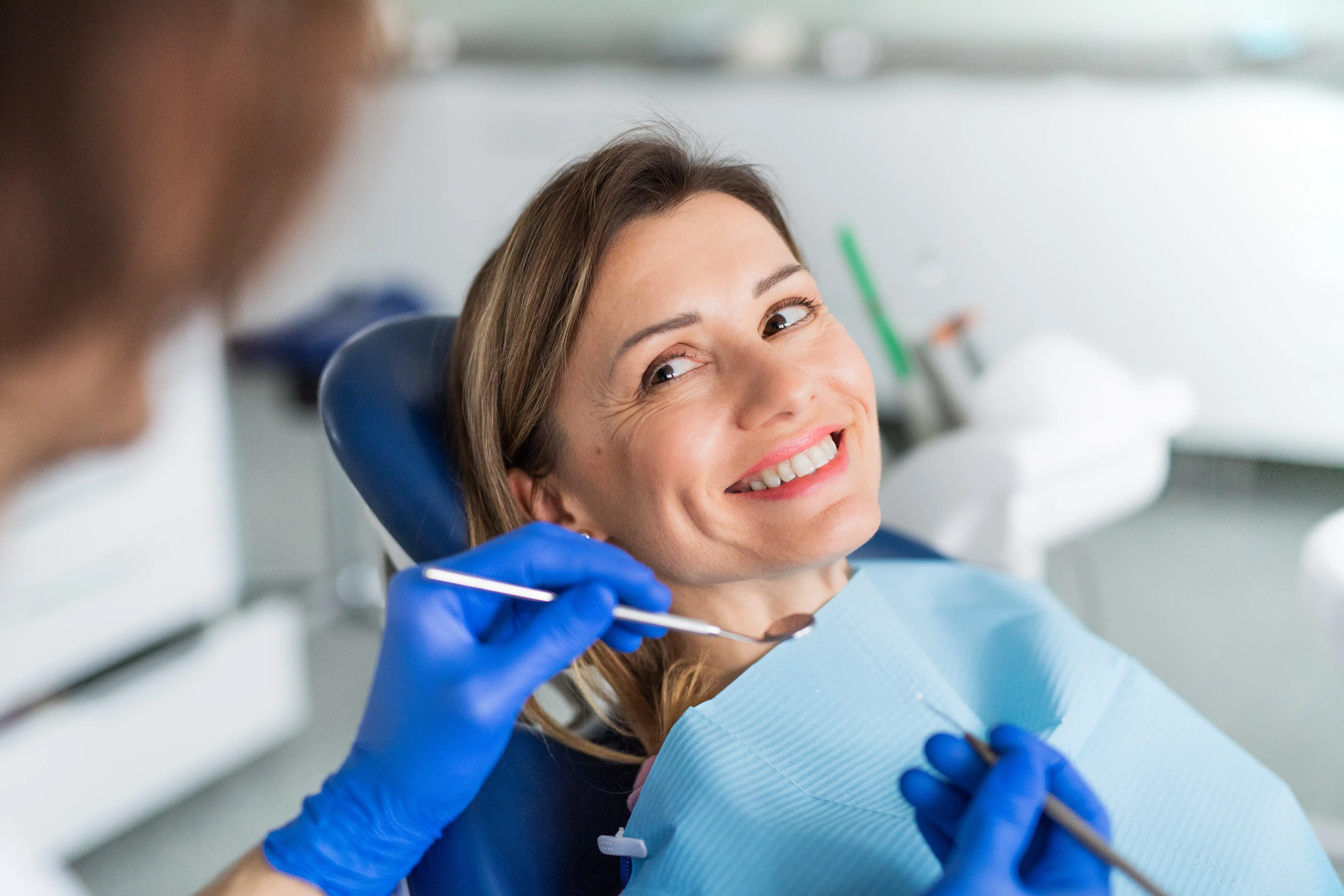 Woman smiling at an dental exam