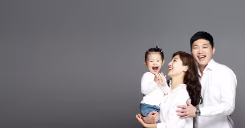 A family with dentist, against a grey background