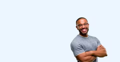 A man arms crossed, against a blue background