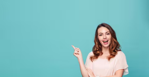A woman pointing, against a teal background