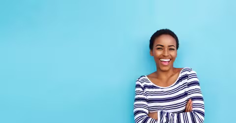 A woman striped shirt, against a blue background